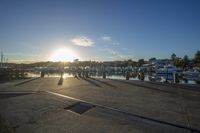 people walking on a pier near a body of water with boats and dock on each side