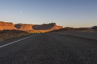 Dawn in the Desert: Highway Through the Mountains and Clear Sky