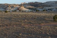 a man riding a horse in the middle of nowhere on a trail through the desert