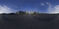 a view of a city through a fisheye lens, and a camera with a person holding a umbrella