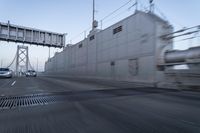 the view from the car on the bridge as it is passing under it and cars driving