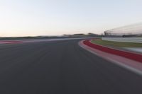 Dawn on the Highway: Racing Red Automobiles on a Race Track