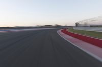 Dawn on the Highway: Racing Red Automobiles on a Race Track