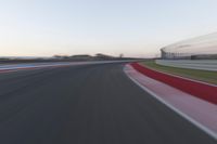 Dawn on the Highway: Racing Red Automobiles on a Race Track