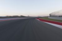 Dawn on the Highway: Racing Red Automobiles on a Race Track