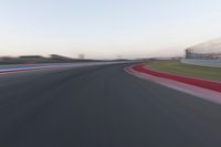 Dawn on the Highway: Racing Red Automobiles on a Race Track