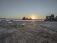 Dawn at the Horizon: Sunlit Beach and Ocean