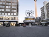 a square that has bicycles parked in the middle of it and a building in the background