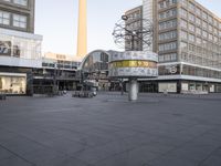 a square that has bicycles parked in the middle of it and a building in the background