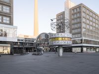 a square that has bicycles parked in the middle of it and a building in the background