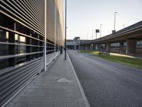 a side walk at an airport with a bike path running alongside it and a building on both sides