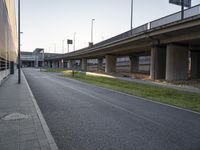 a side walk at an airport with a bike path running alongside it and a building on both sides