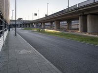 a side walk at an airport with a bike path running alongside it and a building on both sides