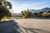 empty empty parking lot with mountains and trees in the background on a sunny day stock photo