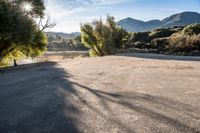 empty empty parking lot with mountains and trees in the background on a sunny day stock photo