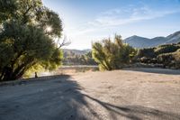 empty empty parking lot with mountains and trees in the background on a sunny day stock photo