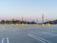 the parking lot has multiple signs on it's posts and poles, as well as street lights