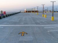 an airport tarmac with three directional signs in the middle and the word parking written on the ground