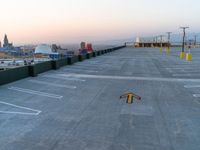 an airport tarmac with three directional signs in the middle and the word parking written on the ground