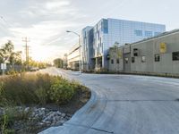a small garden next to a road in front of a building and a street light