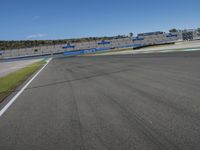 the green road and orange and white stripe line at an event near the racetrack and stadium