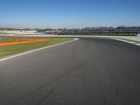 the green road and orange and white stripe line at an event near the racetrack and stadium