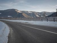 a sign on the side of a road says welcome to canada in front of a mountain