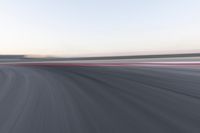 a speed racing track has a red line as it runs through it with motion blurry