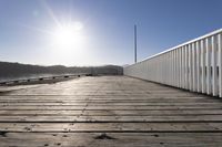 the sun is shining over the bay and a dock on the water's edge