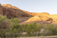 a motor bike is on a mountain road in front of a canyon in the evening