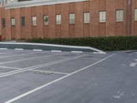 two men in suits are skateboarding on a cement surface in a building parking lot