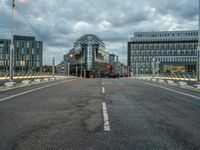 a person on an empty street with tall buildings around them and a city in the background