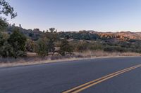 Dawn on Rural Road: Mountain Landscape and Clear Sky