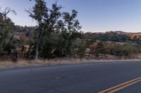 Dawn on Rural Road: Mountain Landscape and Clear Sky