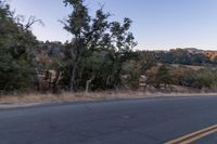 Dawn on Rural Road: Mountain Landscape and Clear Sky