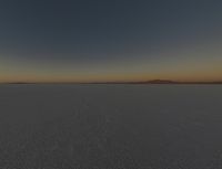 the dark sky above a desert plain with only one plane in sight in the distance