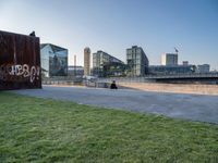 this grass field has been cut short to cover the area in the distance, and it is a grassy area next to an old building