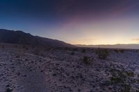 a sunset is lit up over the hills and desert floor near the horizon, where many of the sun sets