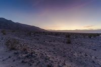 a sunset is lit up over the hills and desert floor near the horizon, where many of the sun sets