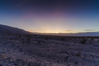 a sunset is lit up over the hills and desert floor near the horizon, where many of the sun sets