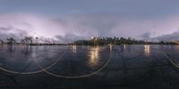 a wet, parking lot with a cloudy sky in the background and clouds flying in the distance