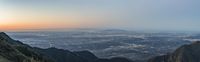 the sunrise on a scenic mountain range over the city of santa anara, mexico