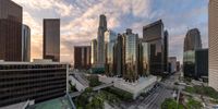 an image of a very high rise city at sunset with lots of skyscrapers around