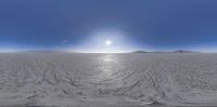 a panorama of the inside of an ice covered desert area with sun streaming through the snow