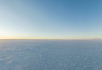 the sun is rising over a flat plain as the sun shines on the horizon