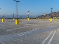 the parking lot at a parking lot in arizona has yellow poles with signs on them