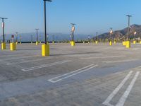 the parking lot at a parking lot in arizona has yellow poles with signs on them