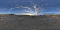 a very pretty fisheye lens with the sun behind it and people standing in the middle of it