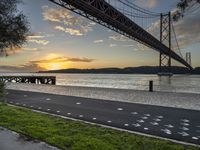 the view of the bay bridge, from the side walk at dusk with painted dots on the pavement