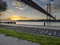 the view of the bay bridge, from the side walk at dusk with painted dots on the pavement